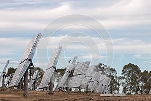 Field of photovoltaic solar panels gathering energy.