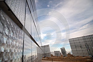 Field of photovoltaic solar panels gathering energy.