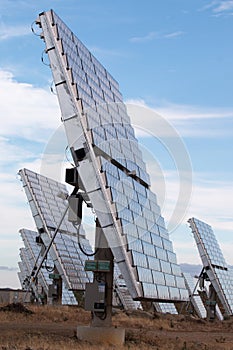 Field of photovoltaic solar panels gathering energy.