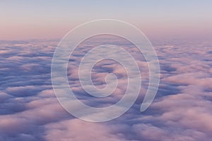 A field of pink clouds at sunset. View from above.