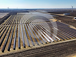 field of rows of solar panels generating electric power