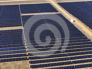 field of rows of solar panels generating electric power