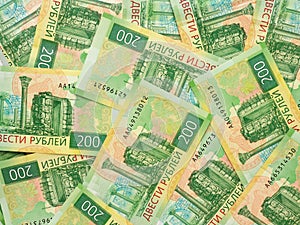 A field of Russian banknotes 200 rubles. View from above. The banknote depicts the sights of Tauric Chersonesos and a map of