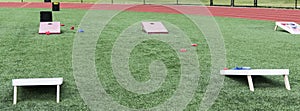 Field set up with cornhole boards for gym classes