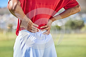 Field, soccer and man with back injury in game tournament with pain, inflammation and backache. Football, athlete and