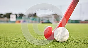 Field, sports and a ball and a stick for hockey, fitness and training in the morning. Closeup, ground and gear or