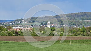 A field of tall grass with a small town in Menden Sauerland photo