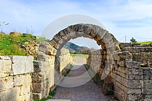 The field where the original Olympics were held viewed through the ruins of the arch through which the Greek atheletes ran in Olym