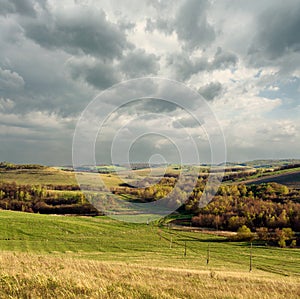 Fields, clouds and hills. Russian steppe landscape.