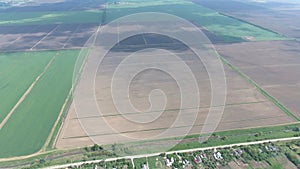 Fields in the Kuban view from a height. Young wheat and plowed field a little further from the village.