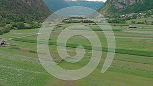 Fields and meadows in valley among mountains aerial view