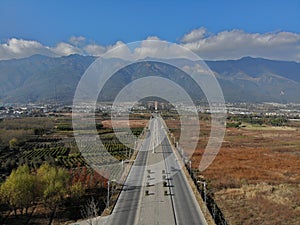 The fields beside the road under the mountains