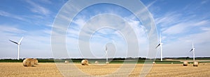 Fields and wind turbine in the north of france under blue sky