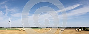 Fields and wind turbines in the north of france under blue sky