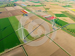 Fields and wind turbines. A wind generator on the field. View from drone. Green energy production.