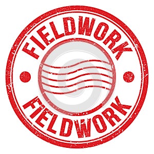 FIELDWORK text written on red round postal stamp sign