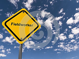 Fieldworker traffic sign on blue sky