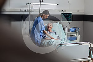 Fiendly doctor hands holding patient hand in hospital room