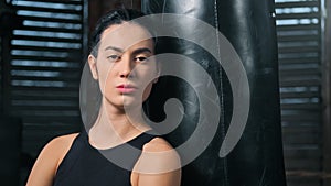 Fierce multiethnic sport girl enjoying break during workout at box studio closeup panning shot