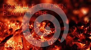 Fiery and blurry surface with hot coals and the inscription Don`t let children play