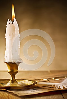 Fiery candle on table