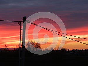 Fiery clouds in the rays of the setting sun