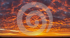 Fiery Orange And Red Sunset Sky With Dramatic Cloud Formations