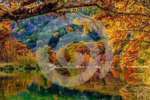 Fiery Orange Reflections on the Frio River at Garner State Park, Texas photo