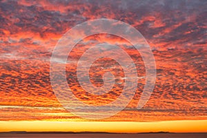 Fiery Orange Sunrise Sky with Dramatic Mackerel Cloud Formation