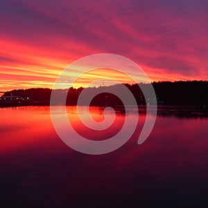 Fiery red and orange sunset over Pacific inlet into the interior of Alaska