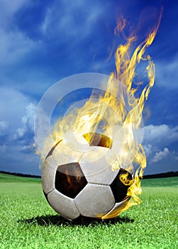 Fiery soccer ball on grass