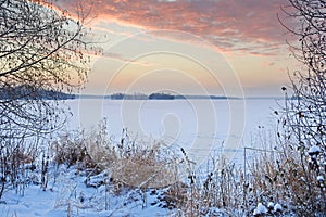 Fiery sunrise over lake Uvildy in winter, southern Ural, Chelyabinsk region photo