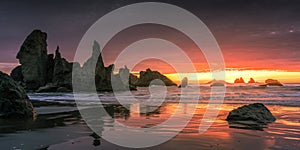 Fiery sunset over Castle Rock Formation at Bandon Beach in Oregon.