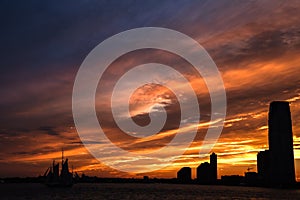 A Fiery Sunset over Jersey City and Hudson River - View from the Battery Park in Manhattan, New York City