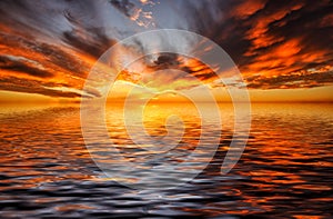 Fiery sunset over the rippling ocean in the tropics