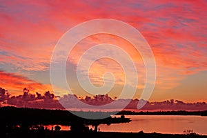 fiery sunset on river with silhouette land, perth