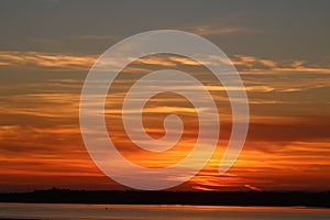 Fiery sunset sky over River Lune at Glasson Dock