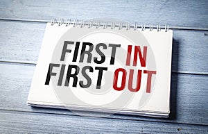 FIFO First in, first out word notebook on wooden background