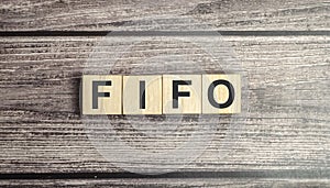 FIFO first in and out symbol. Concept words FIFO first in first out on wooden blocks