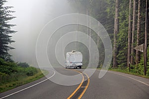 Fifth wheel travel trailer traveling on highway.
