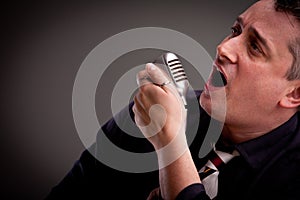 Fifties style singer on a dark background