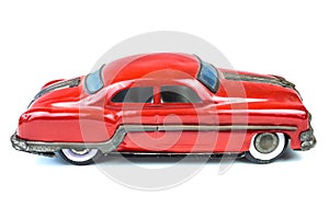 Fifties vintage red car toy isolated on white