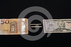 Fifty dollars is fifty euros, notes on a black background