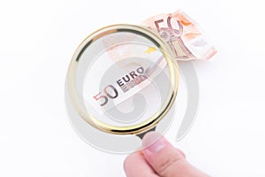 Fifty euro banknote with magnifying glass