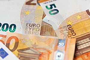 Fifty euro spread out as background, orange banknotes from european union. Monetary union in Europe using euro money and cash