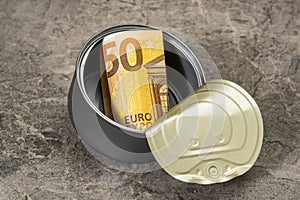 Fifty euro in a tin can falling on the stone background