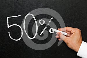 Fifty percent discount or increase on chalk blackboard photo