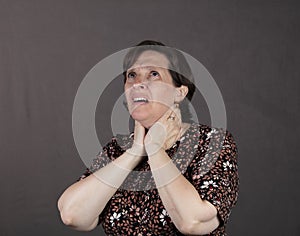 Fifty something woman having throat and neck pain