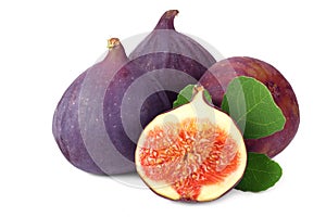 Fig fruit with slices and green leaf isolated on white background