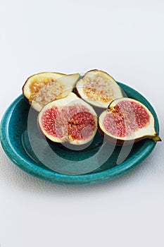 Fig fruits cut on a plate, juicy ripe flesh with seeds